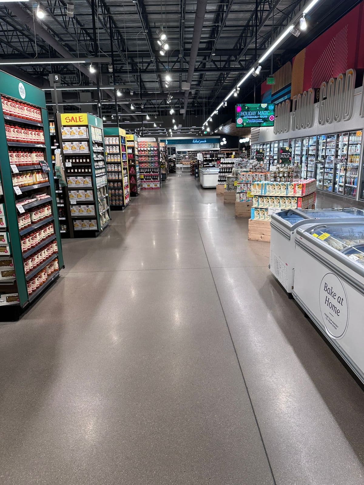 Clean grocery aisle at Whole Foods in Denver with polished floors and stocked shelves